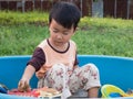 Asian child boy smiling with happy face outdoor with natural background. Royalty Free Stock Photo