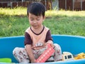 Asian child boy smiling with happy face outdoor with natural background. Royalty Free Stock Photo