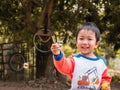 Asian child boy smiling with happy face while playing bubbles outdoor with natural rural background. Royalty Free Stock Photo