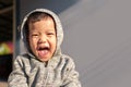 Asian child boy waering hooded sweater having fun Royalty Free Stock Photo