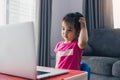 Asian child is dazed by the teachings of online students at home Royalty Free Stock Photo