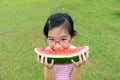 Asian child eating watermelon