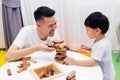 Asian child and father playing with wooden blocks in the room at home. A kind of educational toys for preschool and kindergarten Royalty Free Stock Photo