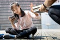 Asian child girl is avoiding reading book, say no,she wants to use a mobile phone to play games or chat with friends, teenage