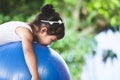 Asian child girl doing stretching exercise on fitness ball Royalty Free Stock Photo