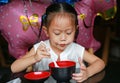 Asian child girl eating miso soup at japanese restaurant Royalty Free Stock Photo