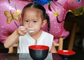 Asian child girl eating miso soup at japanese restaurant Royalty Free Stock Photo