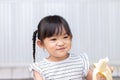 Asian child girl enjoy eating a banana Royalty Free Stock Photo