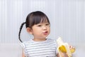 Asian child girl enjoy eating a banana Royalty Free Stock Photo