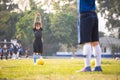 Asian child girl exercise warm up before play soccer with coach and friend.