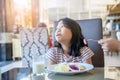 Asian child girl with expression of disgust against tomato in salad Royalty Free Stock Photo