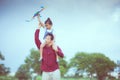 Asian child girl and father with a kite running and happy on meadow in summer in nature Royalty Free Stock Photo