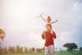 Asian child girl and father with a kite running and happy on meadow in summer in nature Royalty Free Stock Photo