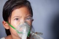 Asian girl has asthma or pneumonia disease and need nebulization by get inhaler mask on her face Royalty Free Stock Photo