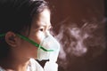 Asian girl has asthma or pneumonia disease and need nebulization by get inhaler mask on her face Royalty Free Stock Photo