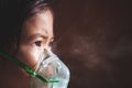 Asian girl has asthma or pneumonia disease and need nebulization by get inhaler mask on her face Royalty Free Stock Photo