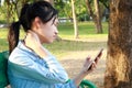 Asian child girl has neck pain,massage her neck,bending head while playing the mobile phone for a long time,stiff neck,muscles