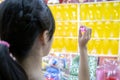 Asian child girl holding a dart and aiming at the balloons, teen playing the dart game for a carnival, female people throws a dart