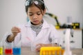 Asian child girl learning science chemistry with test tube making experiment at school laboratory. education, science, chemistry, Royalty Free Stock Photo