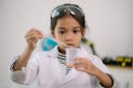 Asian child girl learning science chemistry with test tube making experiment at school laboratory. education, science, chemistry, Royalty Free Stock Photo