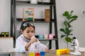 Asian child girl learning science chemistry with test tube making experiment at school laboratory. education, science, chemistry, Royalty Free Stock Photo