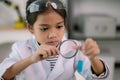 Asian child girl learning science chemistry with test tube making experiment at school laboratory. education, science, chemistry, Royalty Free Stock Photo