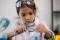 Asian child girl learning science chemistry with test tube making experiment at school laboratory. education, science, chemistry, Royalty Free Stock Photo