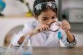 Asian child girl learning science chemistry with test tube making experiment at school laboratory. education, science, chemistry, Royalty Free Stock Photo