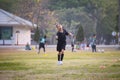 Asian child girl making funny face and running with happiness in the soccer field. Child is happy after win in game. Royalty Free Stock Photo