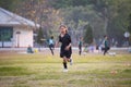 Asian child girl making funny face and running with happiness in the soccer field. Child is happy after win in game. Royalty Free Stock Photo