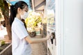 Asian child girl in medical mask,social distancing,keep distance by buying food,snacks beverage or drinking water from vending Royalty Free Stock Photo