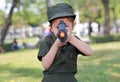 Asian child girl in pilot soldier suit costume with shooting gun up. Dream job concept Royalty Free Stock Photo