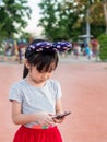 Asian child girl play smart phone Royalty Free Stock Photo
