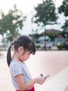 Asian child girl play smart phone Royalty Free Stock Photo