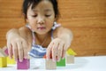 Asian child girl is playing wooden toys Royalty Free Stock Photo