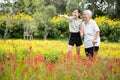 Asian  child girl pointing hand to see something,care,supporting elderly woman in outdoor park,happy smiling senior grandmother, Royalty Free Stock Photo