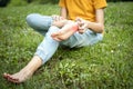 Asian child girl scratch on her foot with hand,foot itch allergy,rash in the grass at park,teenage doesnÃ¢â¬â¢t wear shoes or walk Royalty Free Stock Photo