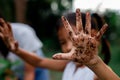 Asian child girl showing dirty hands after planting the tree Royalty Free Stock Photo