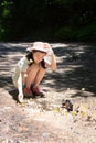 Asian girl sitting in forest,cute little girl studying and learning nature,Group of butterflies on the ground and flying in nature