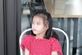 Asian child girl sitting at home, feeling lonely