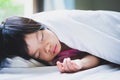 Asian child girl sleeping on the white soft bed. In the morning on summer time. Cute children lying down and rest in peace.