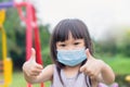 Asian child girl smiling and wearing face mask