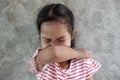 Asian child girl sneezing on hinge joints arm for protect from virus and stop coronavirus outbreak.