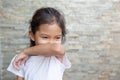 Asian child girl sneezing on hinge joints arm for protect from virus and stop coronavirus covid19 outbreak.