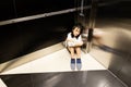 Asian child girl is stuck in an elevator,sad teenager girl sitting alone is crying in a despair with claustrophobia in elevator,