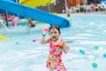 Asian child girl swimming and play water in the blue pool. Royalty Free Stock Photo