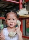 Asian child girl talking on the retro telephone Royalty Free Stock Photo