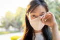 Asian child girl wearing protective mask,people rubbing the eyes due to air pollution,fine dust entering the eye,unclean hand,