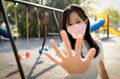 Asian child girl wearing protective medical mask,show stop gesture,hand Royalty Free Stock Photo