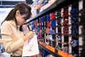 Asian child girl writing or experimenting with a pen on paper to buy,color pens on pen shelves in the shop,teenage student is Royalty Free Stock Photo